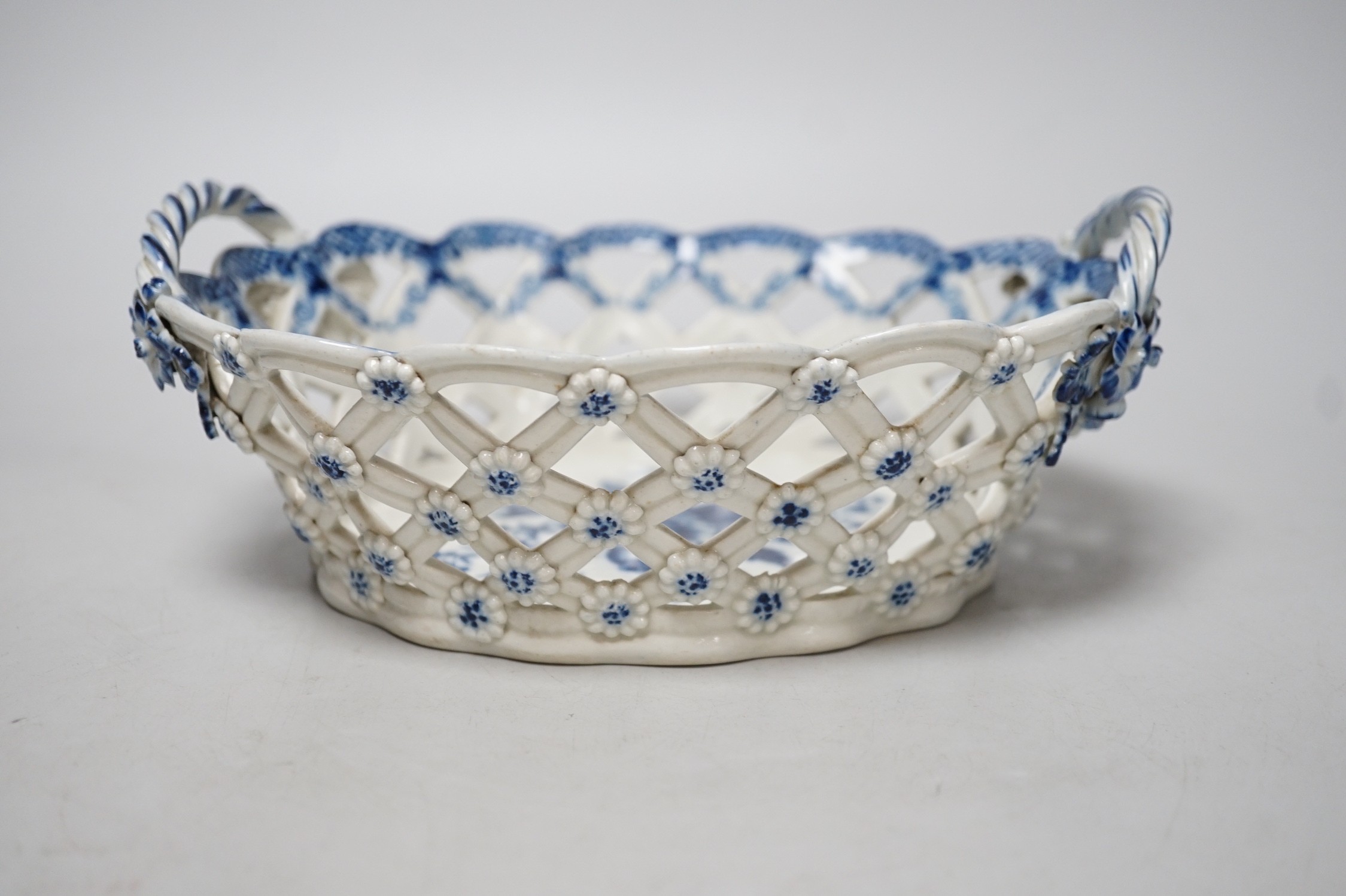 An 18th century Caughley basket printed with fir cones, under a painted border, C mark and very rare IT moulded mark, verso, Ex-Godden Reference Collection, 22cms wide
